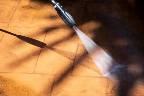 High-pressure hydro jetting nozzle blasting water to clean a drain line in Dallas, TX