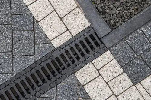 Exterior storm drain channel being cleared to prevent flooding in Dallas, TX